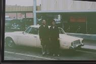 A vintage image of owers Russell and Grace Petersent standing in front of the dealership.